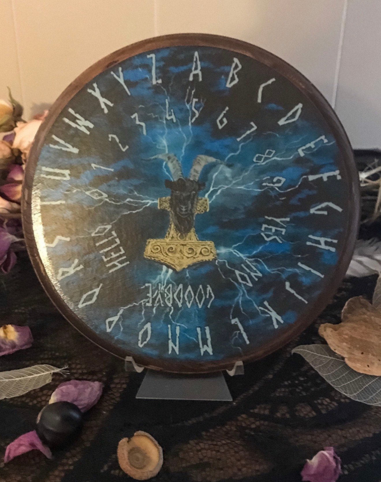 Hand-painted spirit board featuring Thor's hammer and lightning storm by Loren Morris